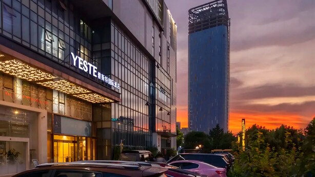 A modern building with a sign reading 'YESTE' and a tall skyscraper in the background. - Yeste International Hotel Wuhan Tiandi (Wuhan)