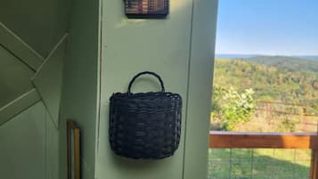 A wall with a house-shaped decoration and a woven basket.
