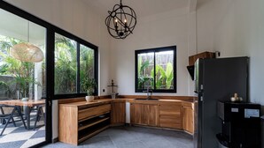 A modern kitchen with a large window, a built-in sink, and a refrigerator. - Orfeas Villas 1 - Luxury 2BR Canggu Private Pool, Rooftop Lounge (Kabupaten Badung)