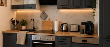 Fridge, coffee/tea maker, highchair, dining tables