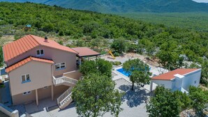 A residential area with a two-story house, a swimming pool, and a playground. - Perfect 3-bedroom house with heated pool in peaceful Šestanovac (Šestanovac)