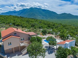 A residential area with a two-story house, a swimming pool, and a playground. - Perfect 3-bedroom house with heated pool in peaceful Šestanovac (Šestanovac)