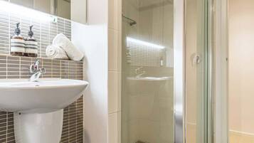 Shower, hair dryer, towels, shampoo