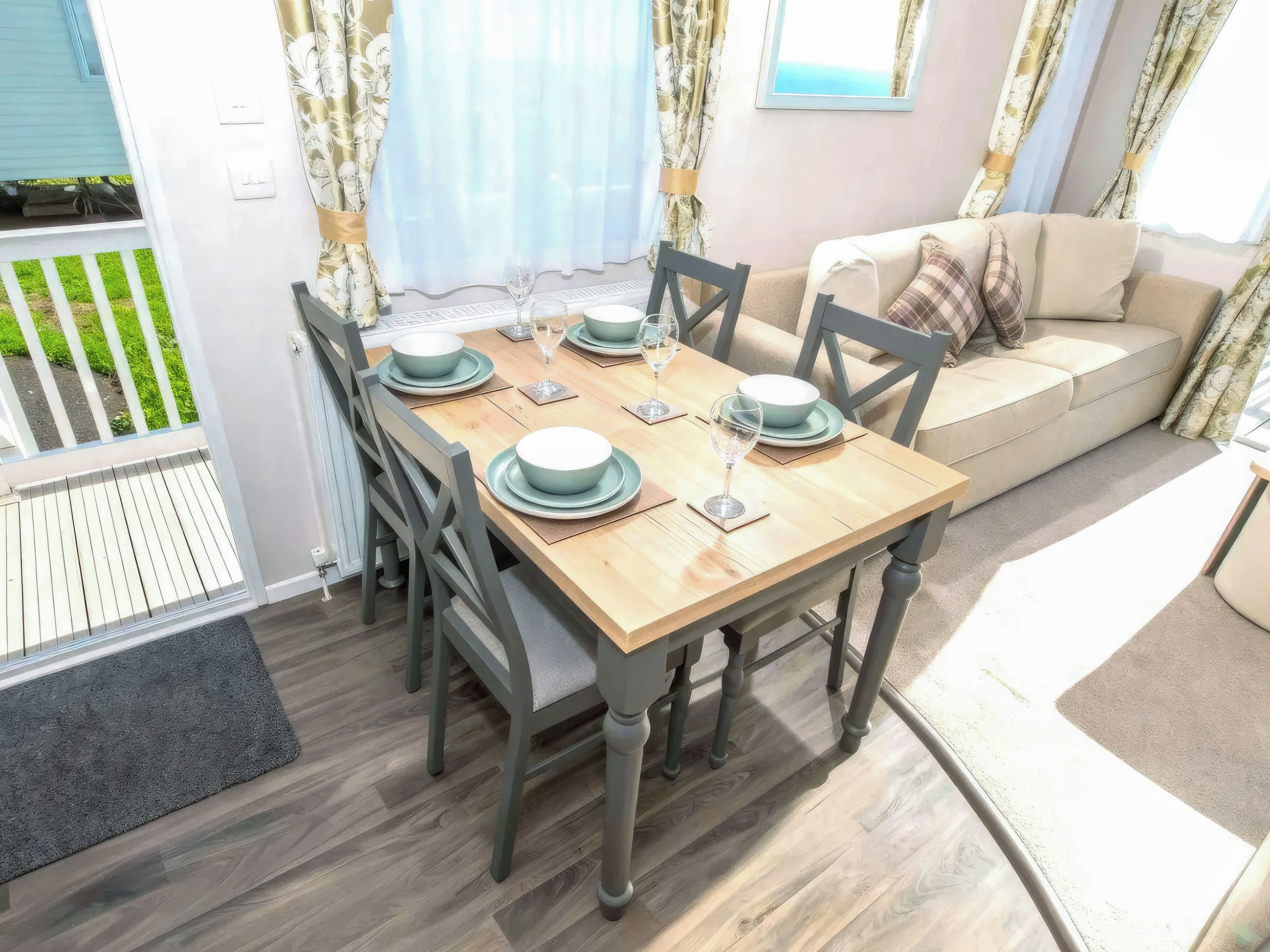 A dining area with a wooden table, chairs, and a sofa.