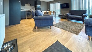 A modern living room with a sofa, a coffee table, and a rug. - Bellstane Chalet - UKC9440 (Glasgow)