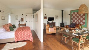 A room with a bed, a sofa, a dining table, and a fireplace. - 2 bedroom accommodation in Cardiff (Cardiff)