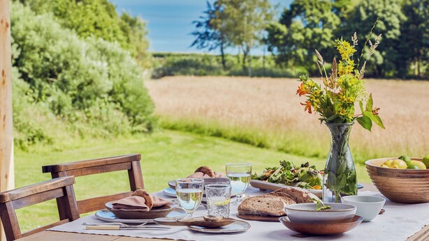 A table set outdoors with a view of a field and trees. - 2 bedroom accommodation in Cardiff (Cardiff)