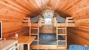 A compact wooden cabin with bunk beds, a small desk, and a window. - Relax in our stunning seaside glamping pods in Peterhead. (Banff)