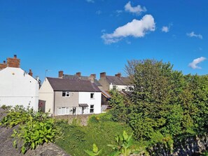 A residential area with houses, a clear sky, and greenery. - Set in the heart of Conwy Town, with views over the railway and Castle walls. (Conwy Town)