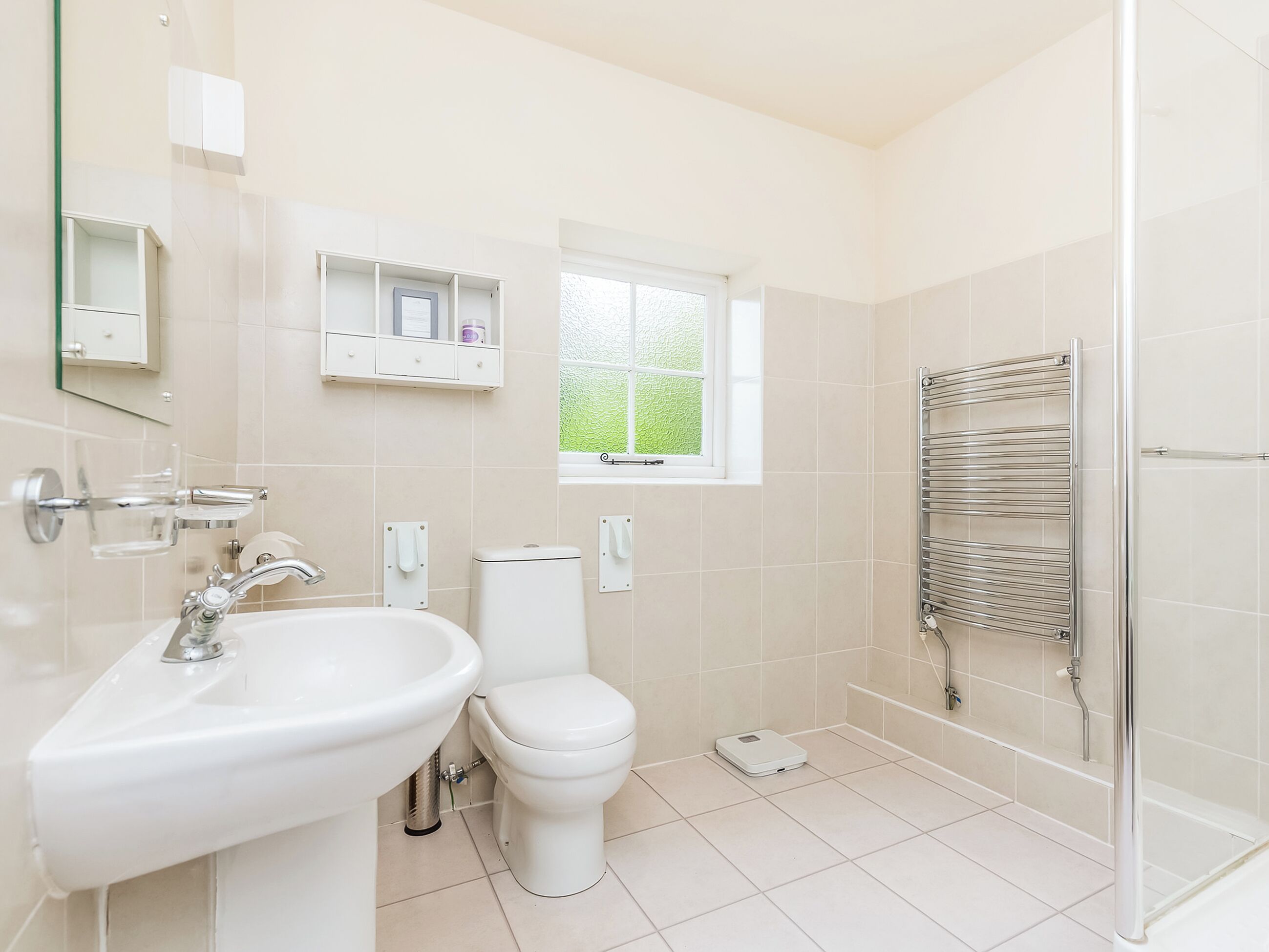 A bathroom with a sink, toilet, and shower.