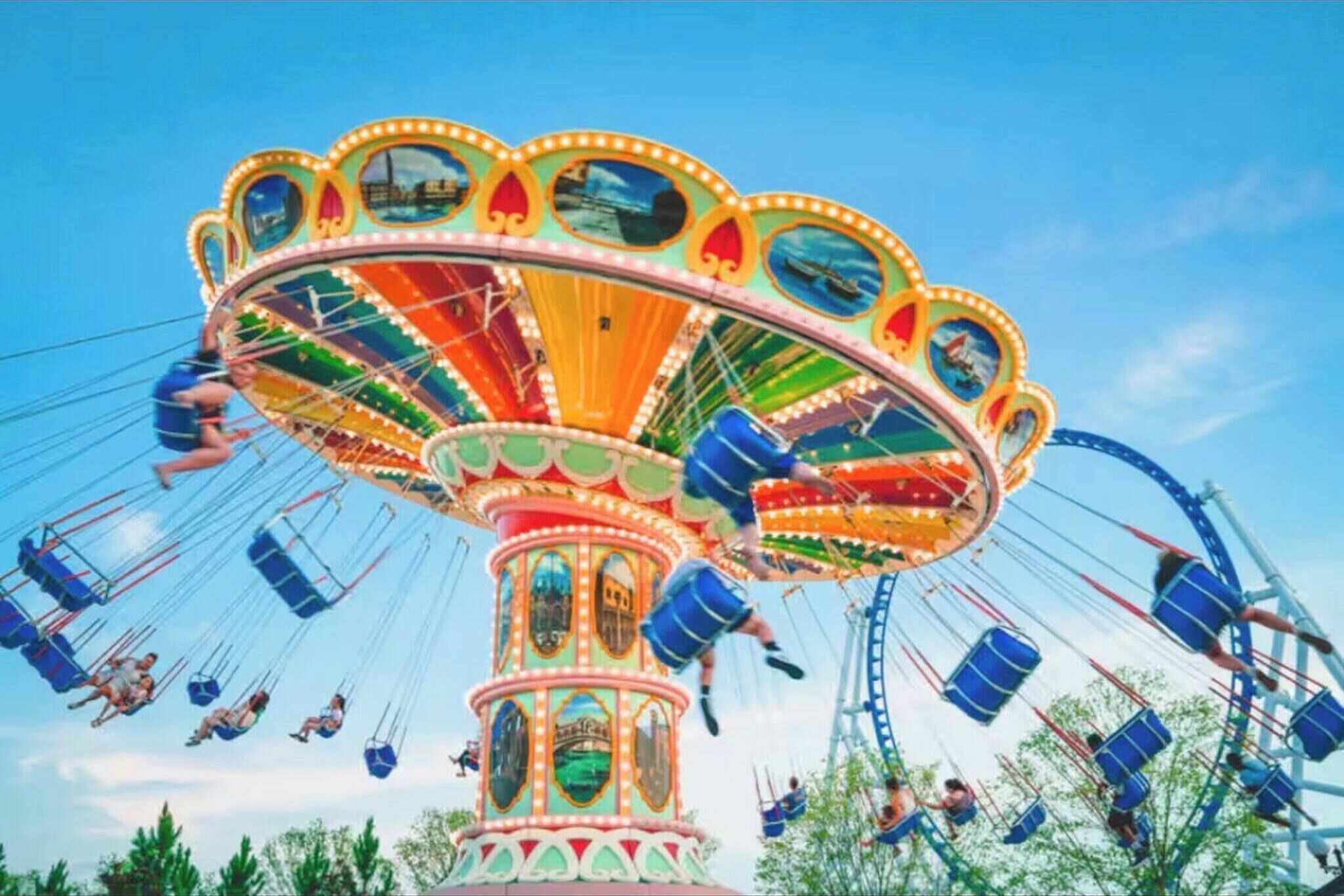 A large, ornate amusement ride with multiple swinging seats.