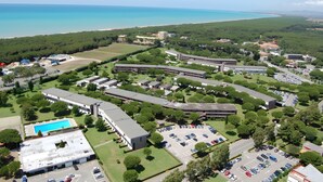 Vista aerea di un campus con diversi edifici, una piscina e un parcheggio.