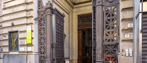 An ornate entrance with a large archway and decorative metal gates.
