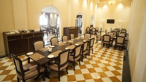 A dining area with a checkered floor, multiple tables, and chairs. - Anant Mahal Jaipur (Jaipur)