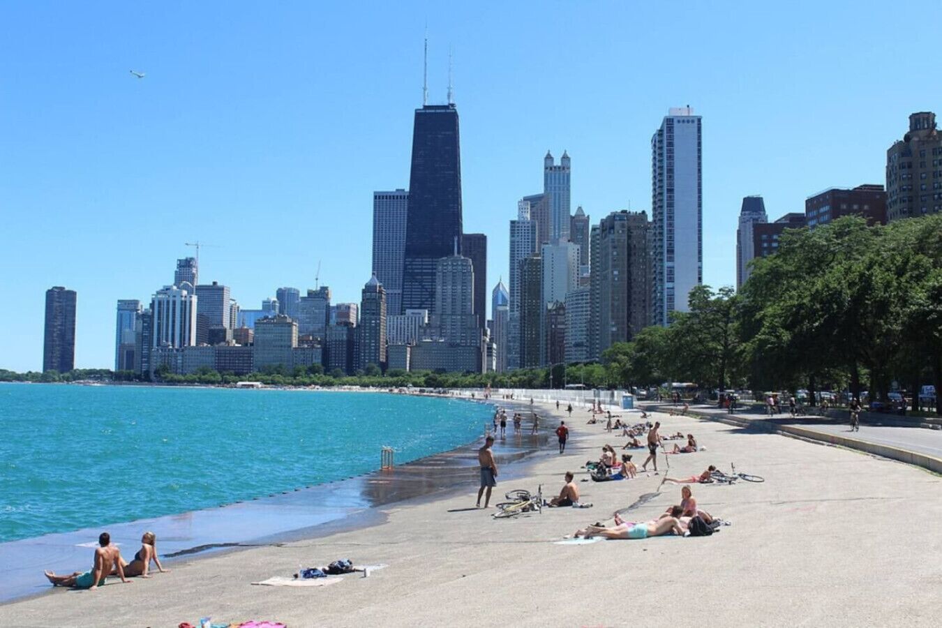Sandy beach w/ city skyline views, perfect for lakeside strolls & relaxing days