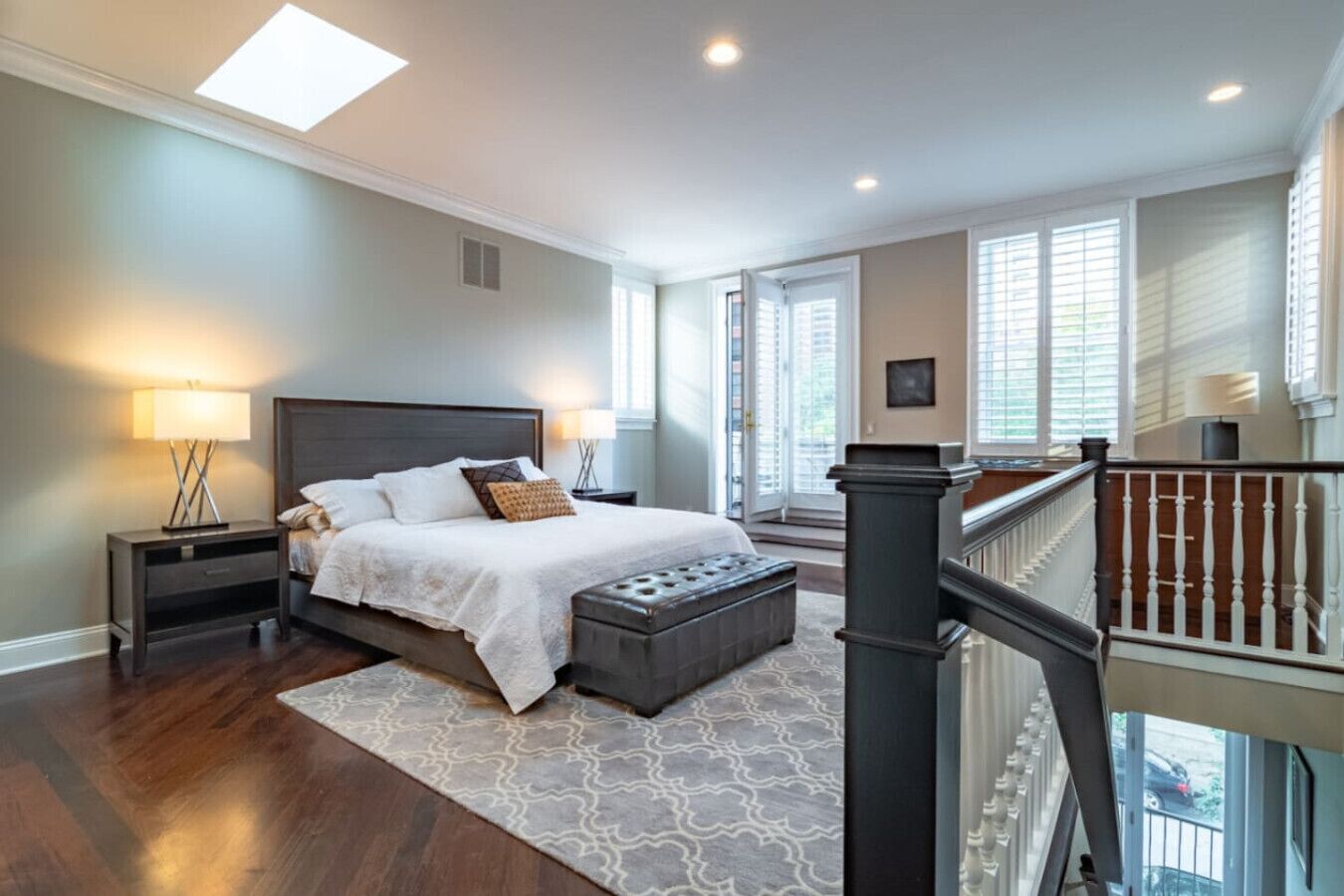 Spacious loft-style bedroom w/ seating nook, large windows & bright open feel