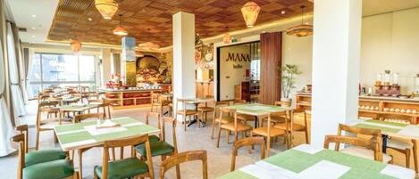 A restaurant with wooden tables and chairs, a buffet area, and a view of the outside.