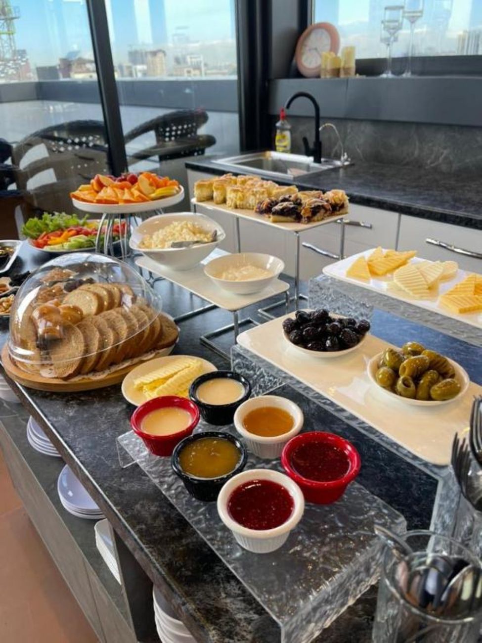 A buffet setup with various food items and condiments.
