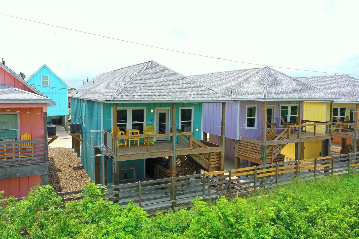 A multi-story building with a wooden deck and stairs.