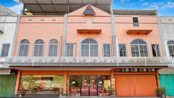 A hostel with a prominent 'S KOSTEL' sign, large windows, and a balcony.