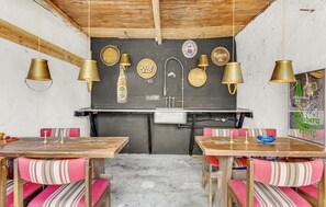 A rustic kitchen with a sink, hanging lights, and a wall adorned with beer labels. - 5 bedroom lovely home in Sydals (Sydals)