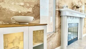 A marble wall, a fireplace, and a cabinet with glass doors. - LUX 6BR/3BA Stylish House w/piano, bar, pool&spa (Las Vegas)