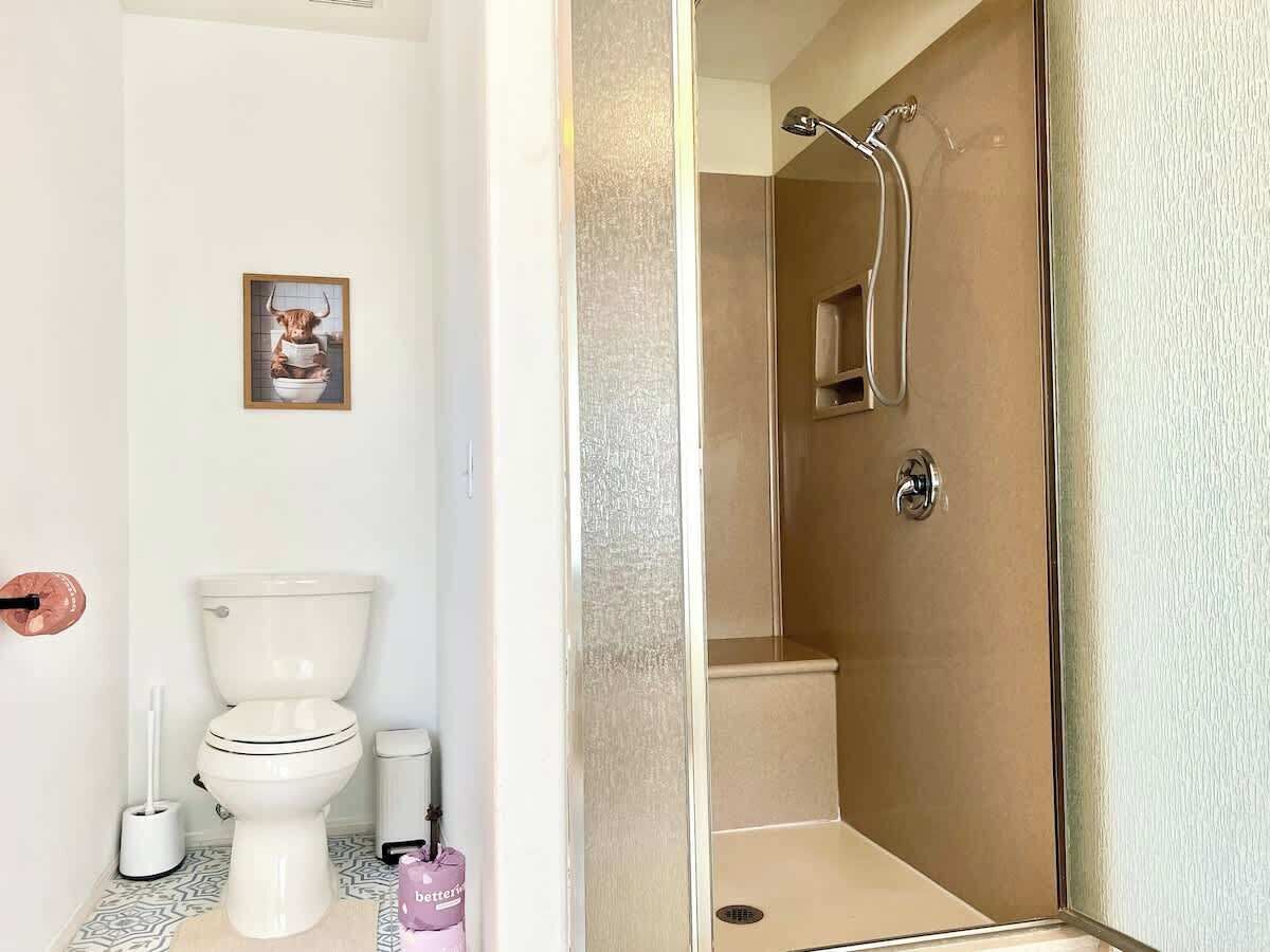 A bathroom with a toilet, bidet, and shower.