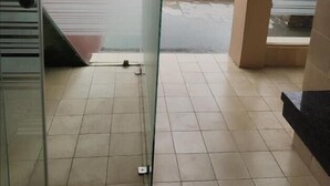 A room with a glass door leading to a balcony with a view of a green field. - Rio Vista (Razole)