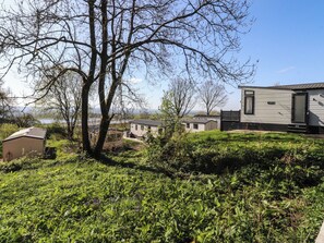 A mobile home with a front porch and a small attached garage. - Beacon Fell Cottage 2 (Preston)
