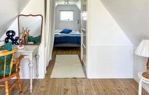 A bedroom with a bed, a mirror, a desk, and a chair. - Nice home in Fjälkinge (Fjälkinge)