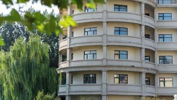 A multi-story building with balconies and windows.