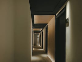Un pasillo con puertas a ambos lados que conduce a habitaciones.