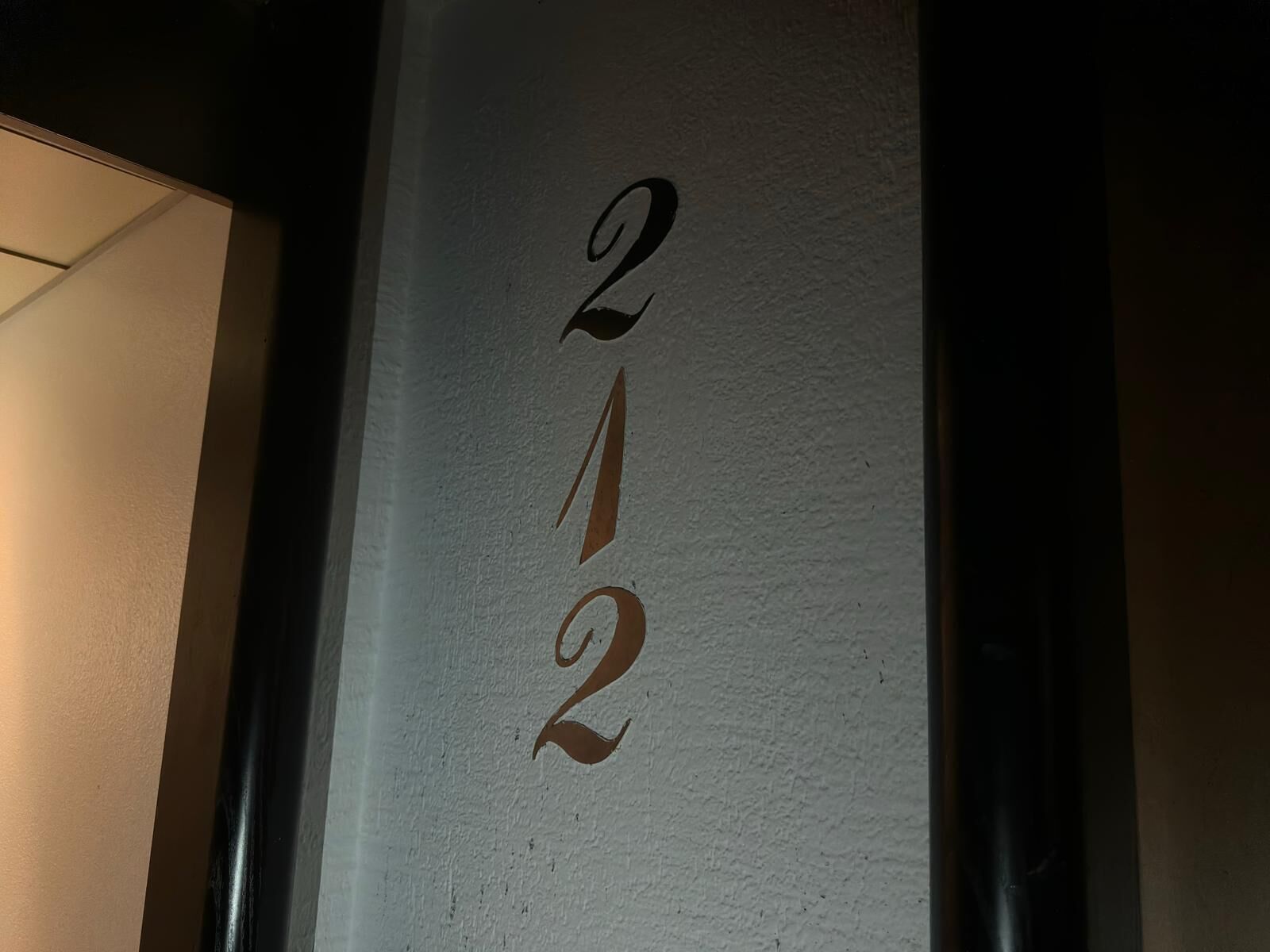 A wall with the numbers '212' in a stylized font.