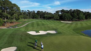 A golf course with sand bunkers, trees, and a clear sky. - 3-B/R Townhome with Garage Murrells Inlet, The Clubhouse Retreat 
Near TPC (Murrells Inlet)