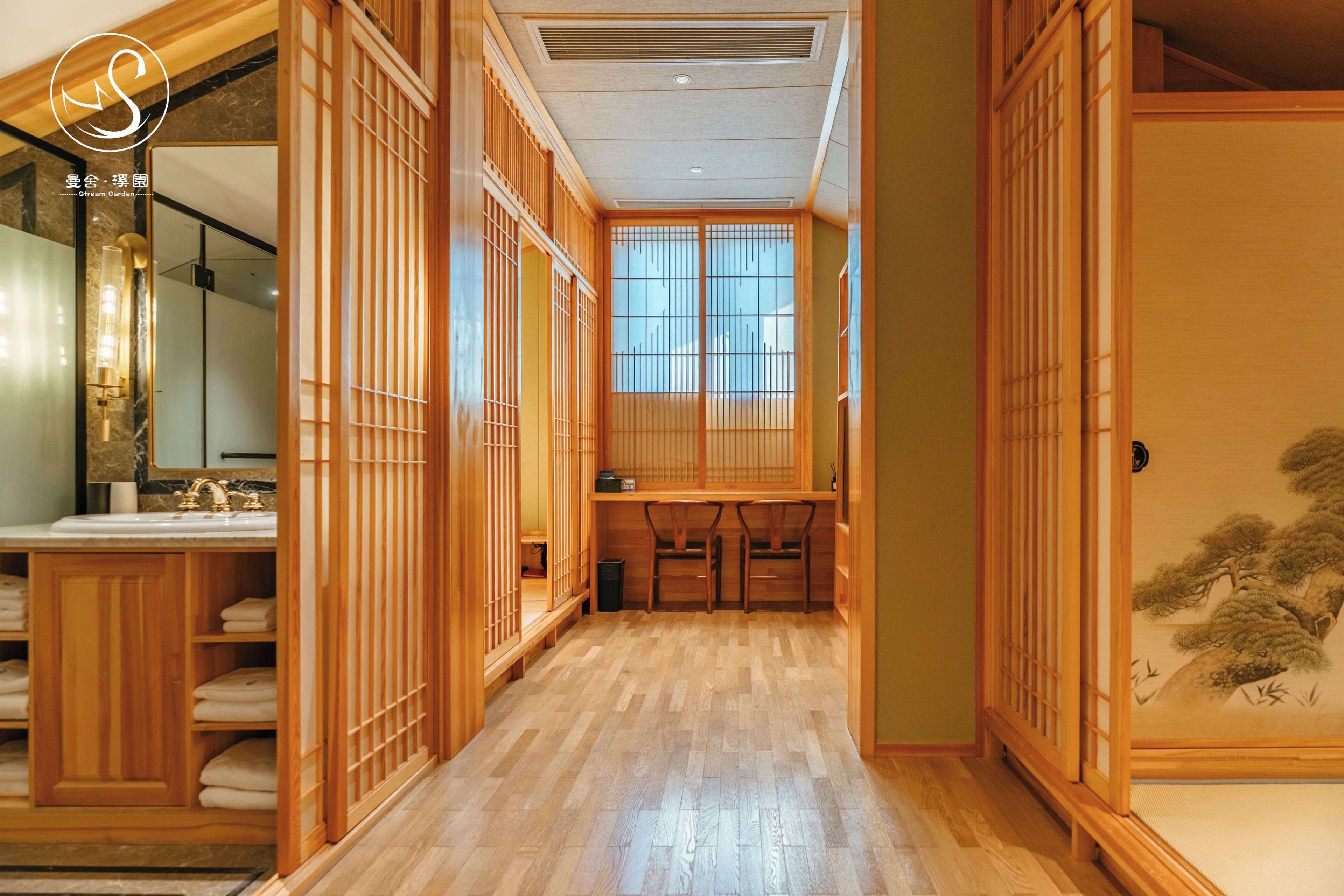 A traditional Japanese-style room with sliding doors, a wooden floor, and a view through a window.