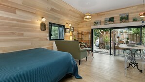 A room with a bed, a chair, a table, and a view of the outdoors. - Maison “Gîte Mimosas” with Terrace and Wi-Fi (Marzan)