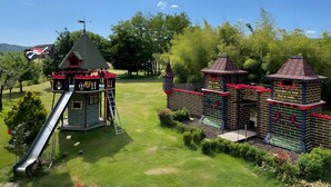 A playground with a slide and climbing structures. - Gîte for 8 – La Fontaine Des Rollands: Mountain View, Shared Pool, Wi-Fi (Saint-Vérand)