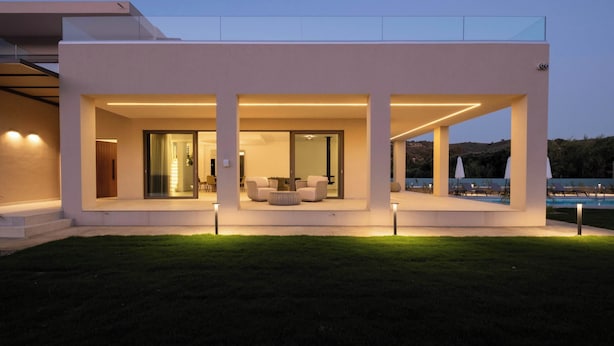 A modern house with a covered patio, outdoor seating, and a pool. - Villa Neratzia-Luxury Escape (Neratzia)