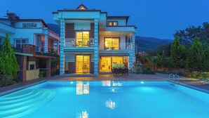 A two-story house with a swimming pool in front. - Premium 4 Bedroom Villa in Oludeniz (Fethiye)