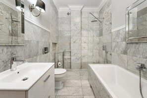 A modern bathroom with a bathtub, toilet, and shower. - ShortStayPoland Ludna B195  (Warszawa)