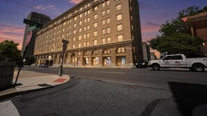 A large brick building with multiple windows and a corner entrance, located at a street intersection. - Contemporary 2BR near dining and transit (Reading)