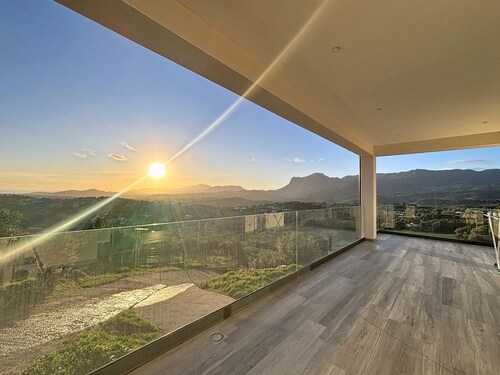Upper floor of a villa with a private pool and views of the sea and mountains