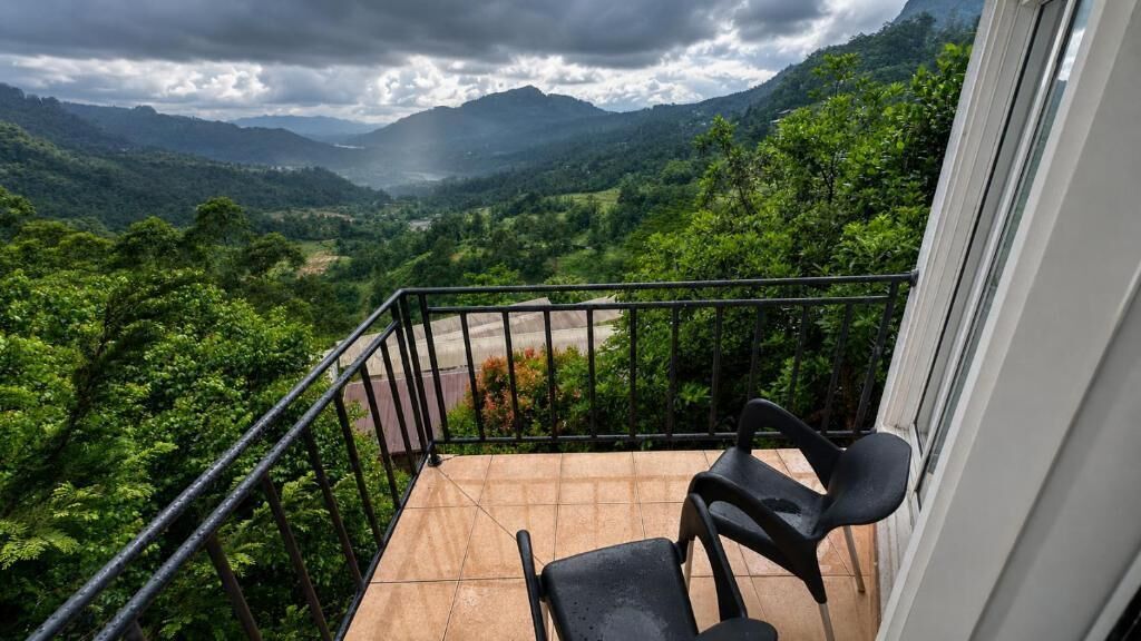 A balcony with a view of a mountainous landscape.