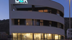 A modern building with a sign reading 'DCR Dental Center Repic.' - Trogir sky view suite (Trogir)