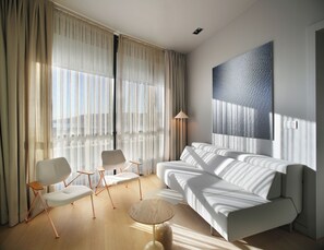 A modern living room with a sofa, chairs, a lamp, and a large abstract painting. - Trogir sky view suite (Trogir)