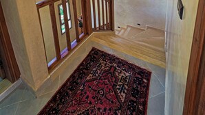 A staircase with wooden railings, a patterned rug, a hanging lantern, and a small window with natural light. - Perfect 2-bedroom Villa with Pool in delightful Ourika (Ourika)