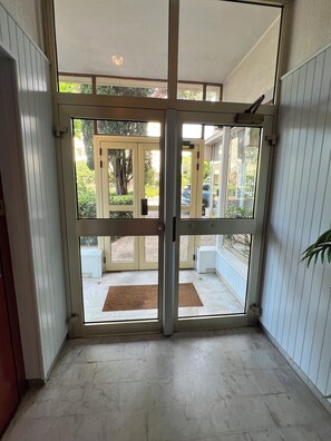 A view through a glass door leading to a covered outdoor area with a doormat. - Newly renovated apartment in the center of Saint Raphaël. (Saint-Raphaël)