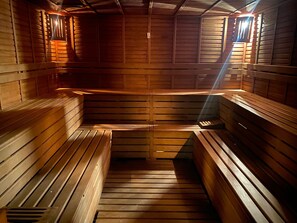 A sauna with wooden benches and slatted walls.