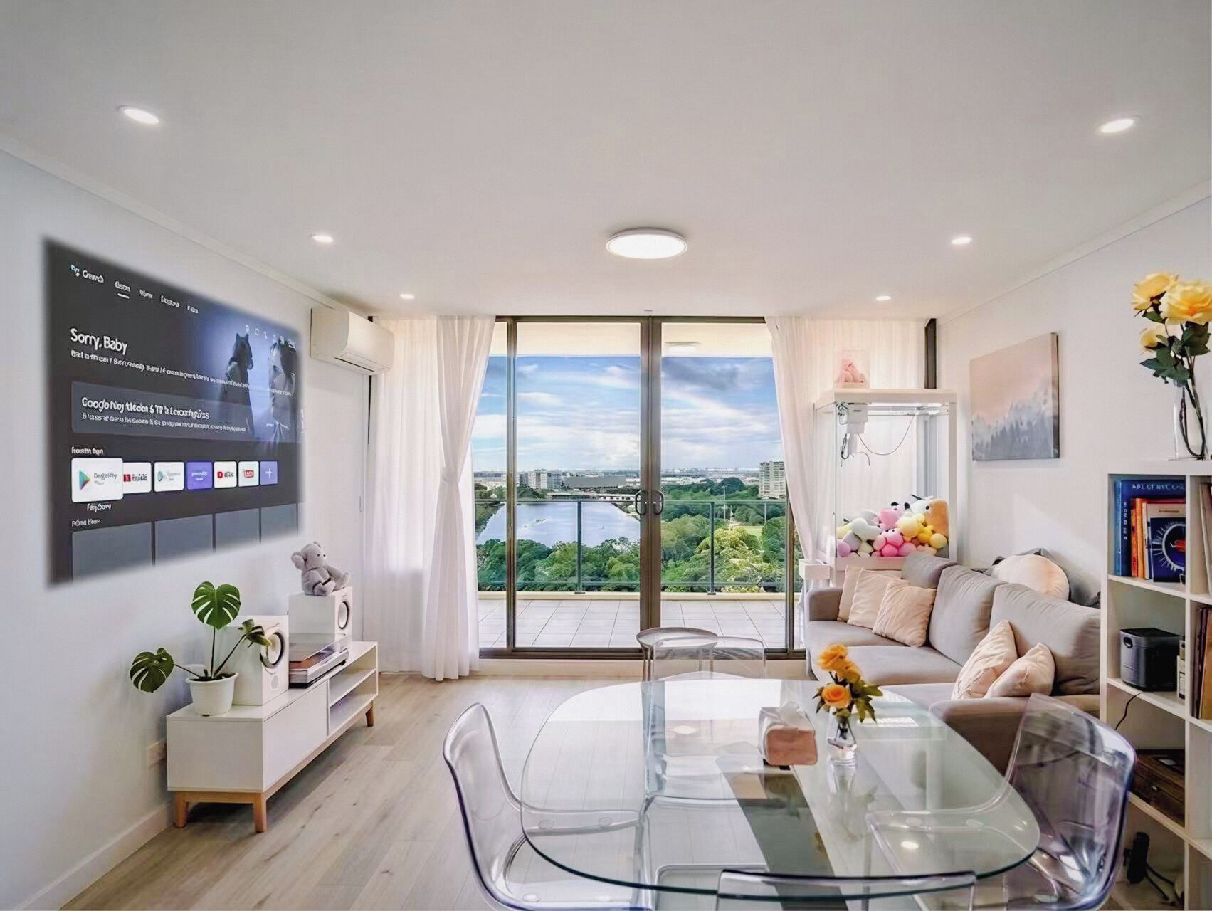 A modern living room with a large TV, a dining table, and a sofa.
