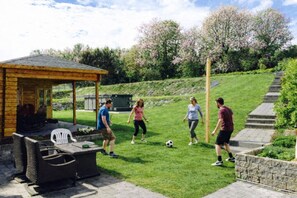 A patio area with a wooden pergola, outdoor seating, and a grill. - “Exclusive Chateau Estate, for 14 Guests with Pool Near Tongeren” (Tongeren-Borgloon)
